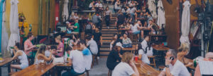 Lots of people sitting at tables in a café